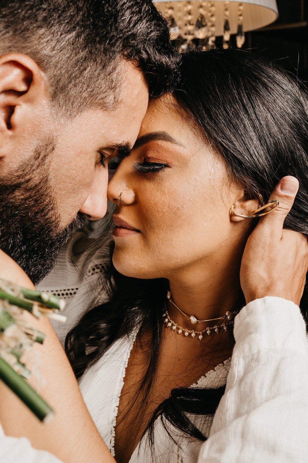 Crop ethnic newlywed couple in moment of kiss